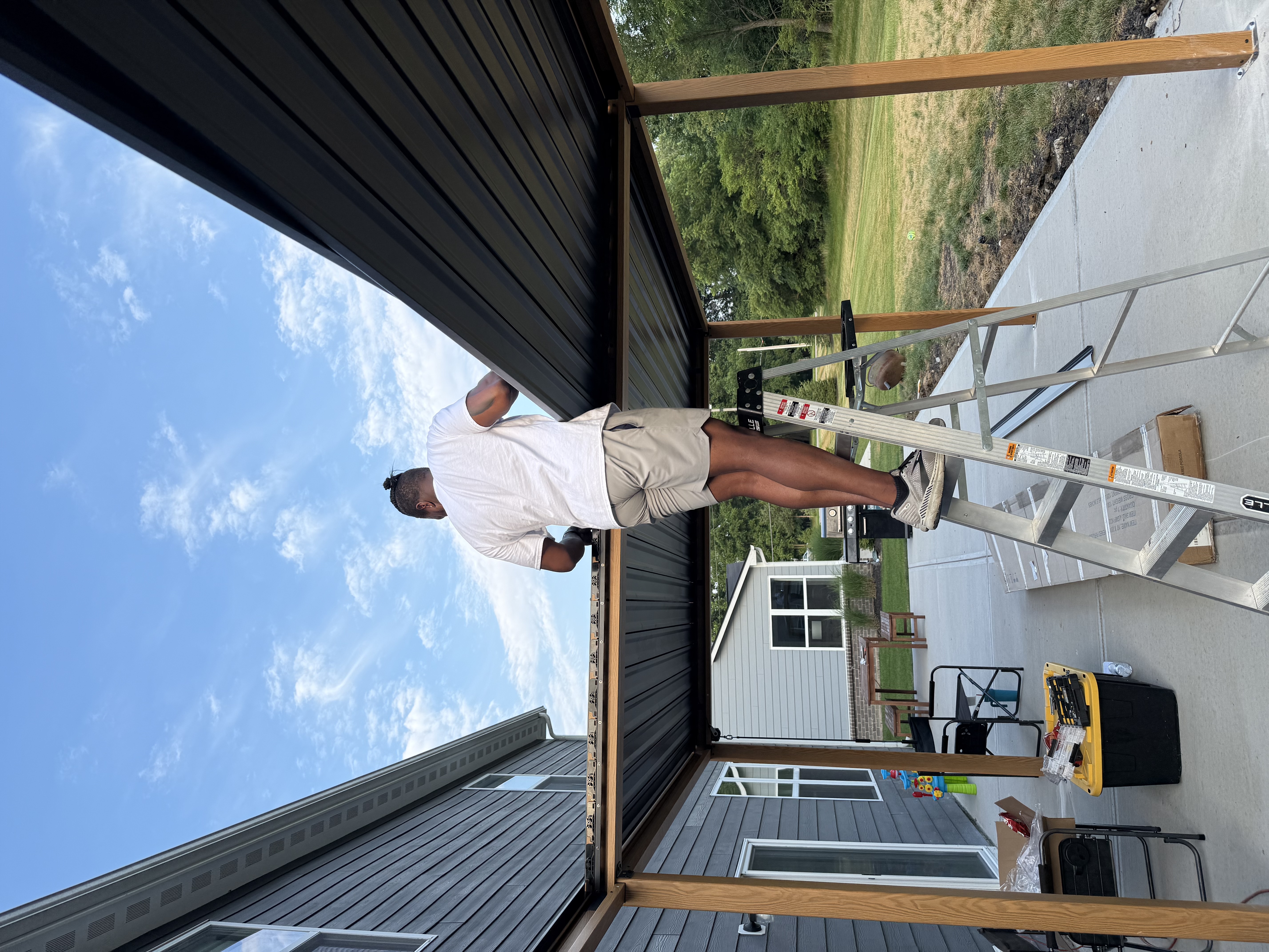 Pergola roof panels being installed